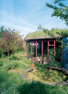 
Domed windows peek through the home’s sod roof, which is barely distinguishable from the surrounding landscape.
